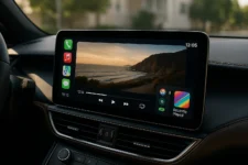 iOS 26 CarPlay video playback feature on parked car dashboard